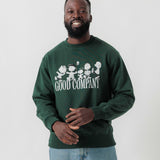 Vorderansicht eines männlichen Models im grünen Box Sweater mit Peanuts Good Company-Print.