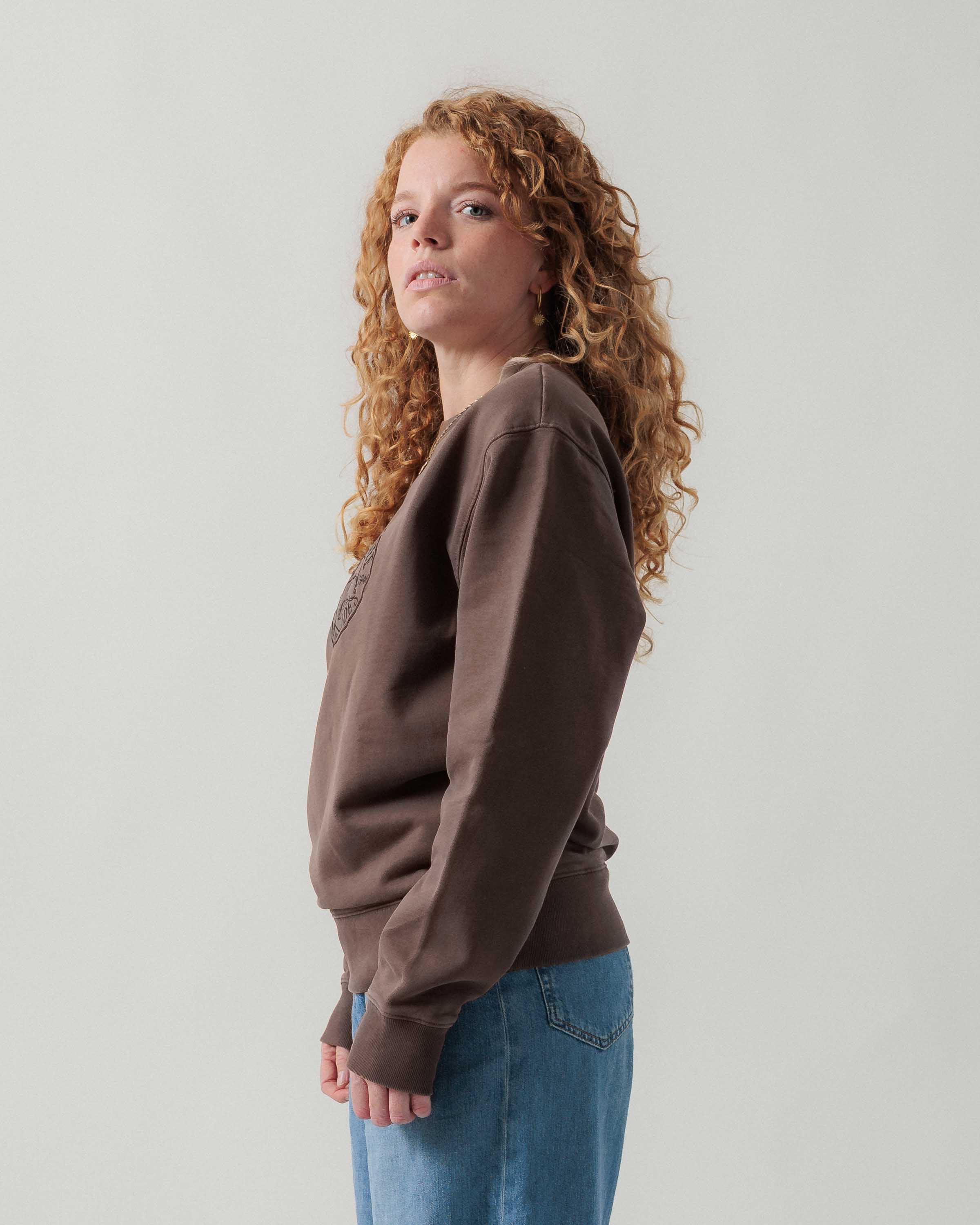 Seitenansicht eines weiblichen Models im braunen Box Sweater.