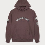 Vorderansicht des braunen Boxer Hoodies mit Lucky Luke Badges-Motiv. „LUCKY LUKE since 1946“-Schriftzug.