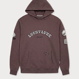 Vorderansicht des braunen Boxer Hoodies mit Lucky Luke Badges-Motiv. „LUCKY LUKE since 1946“-Schriftzug.